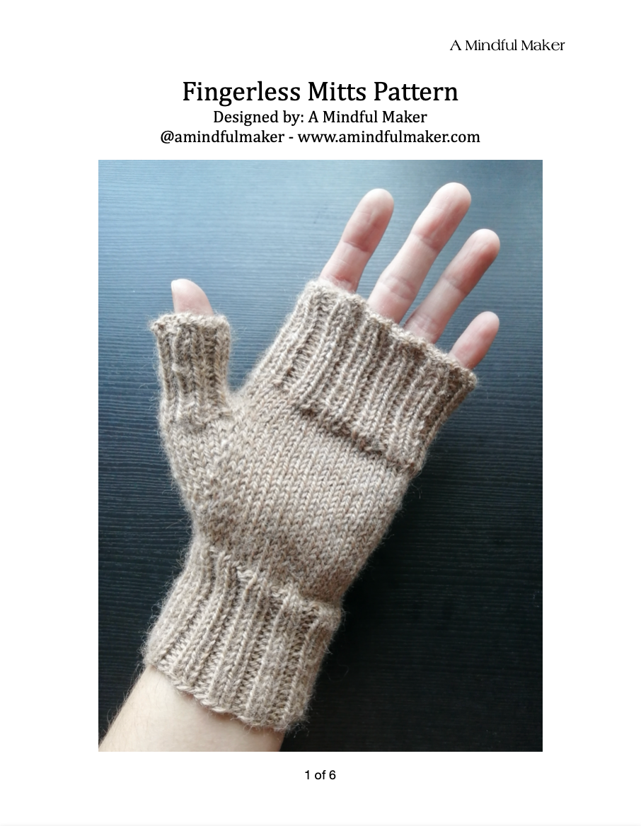 A pair of beige fingerless mitts displayed on a hand.