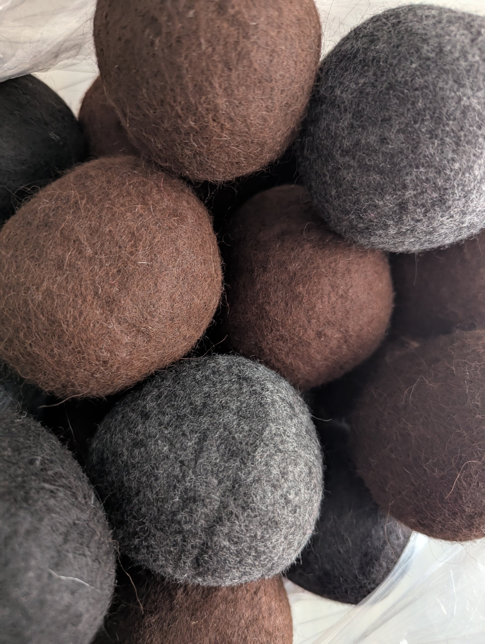 Close-up of felt balls in various shades of brown and gray.