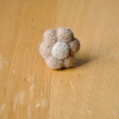 Needle felt air freshener in the shape of a beige flower