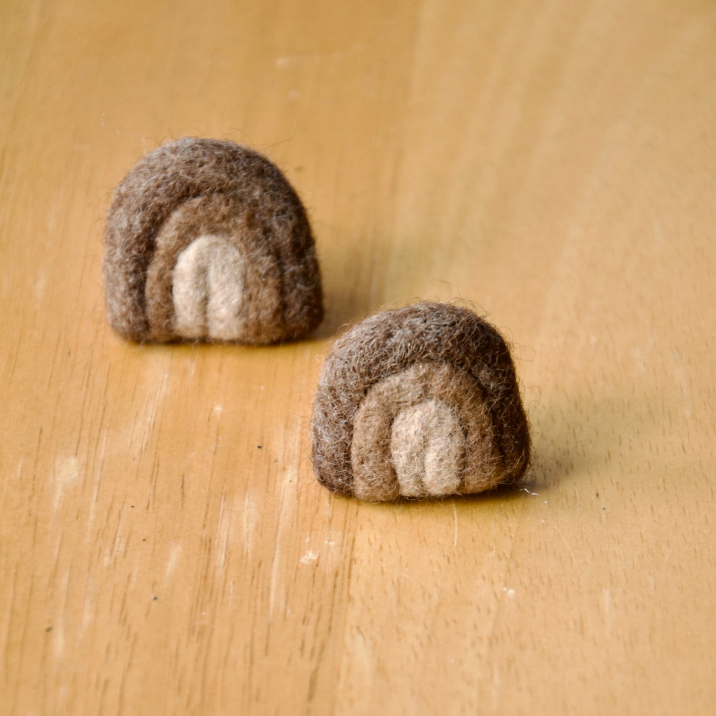 Needle felt air freshener in the shape of a brown rainbow