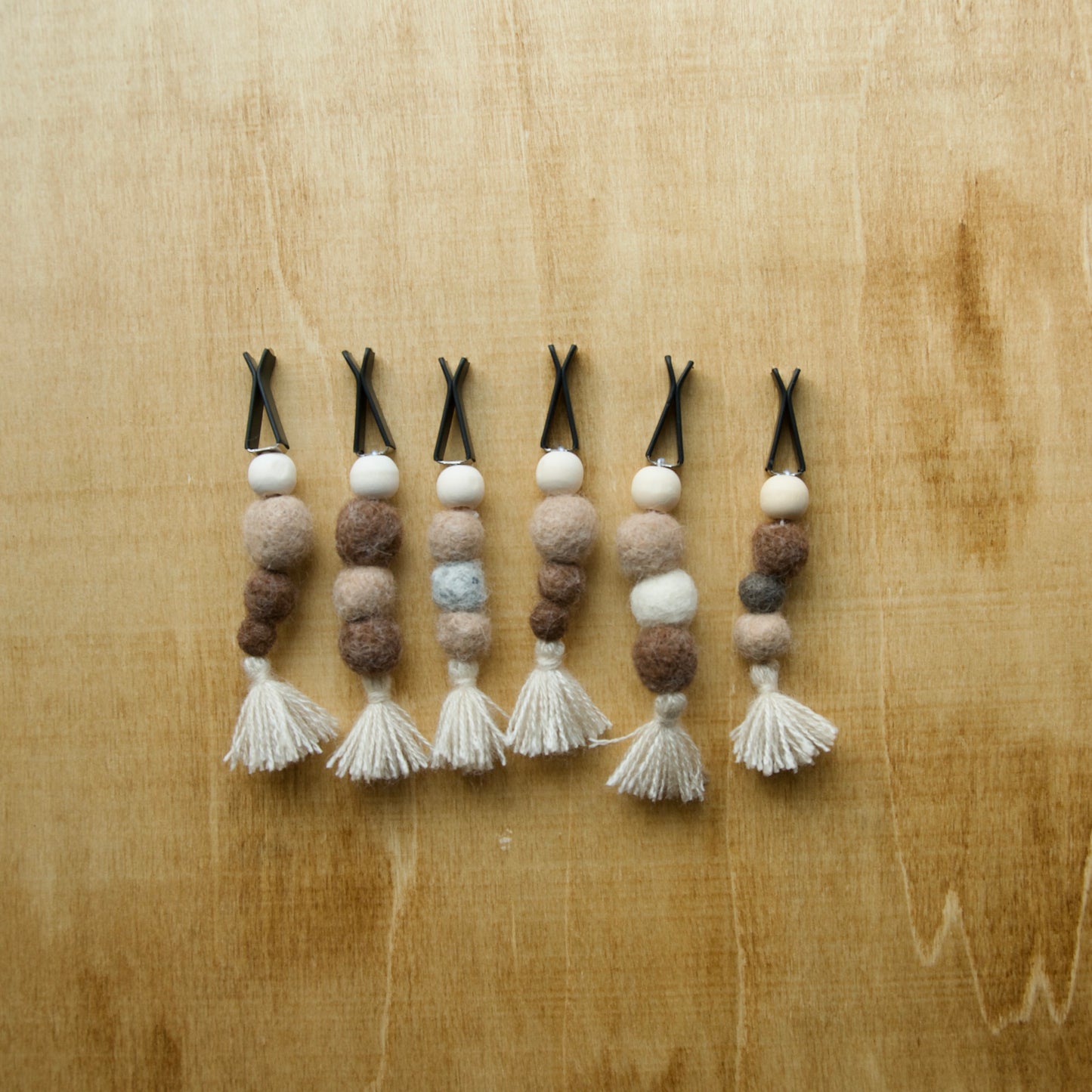 Felted air freshener collection over a wooden background