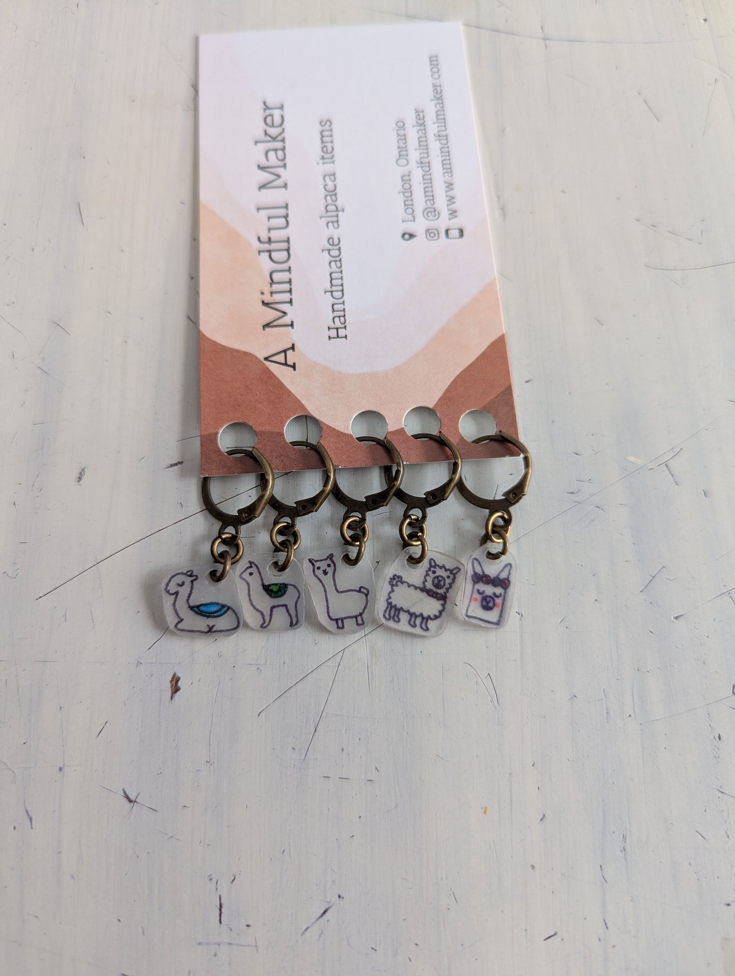 Set of keychains with llama designs on a 'A Mindful Maker' branded card.