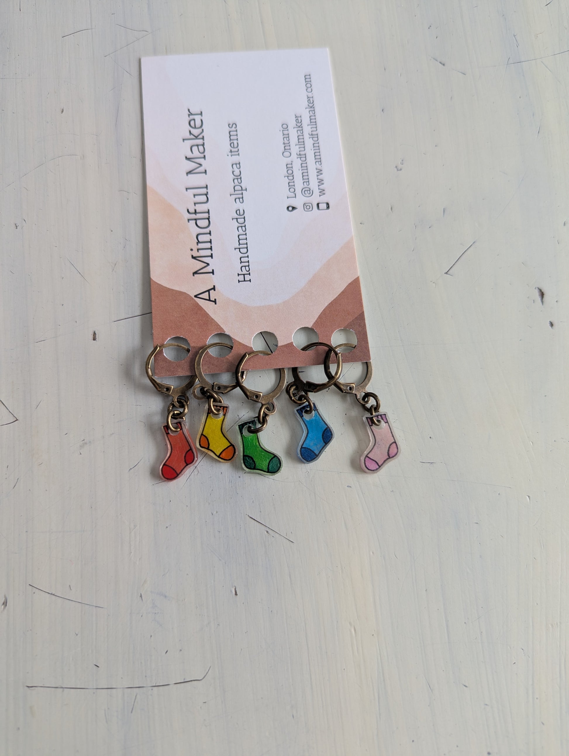 Keychains with colourful sock charms on a white background