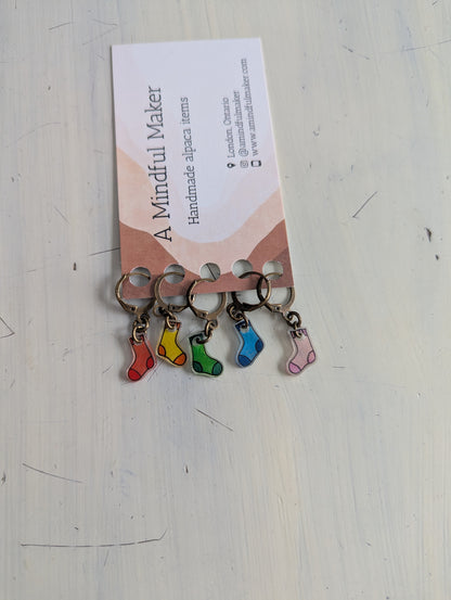 Keychains with colourful sock charms on a white background
