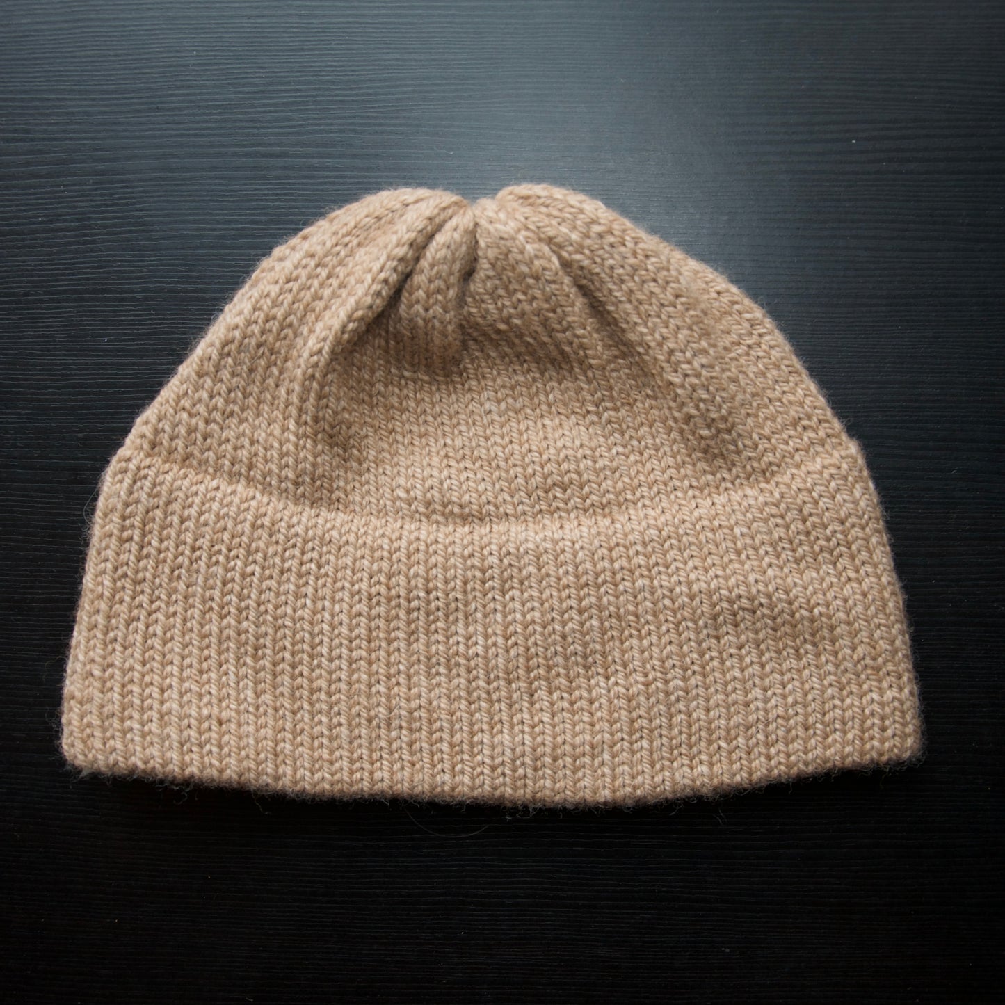 Knitted beanie on a dark background