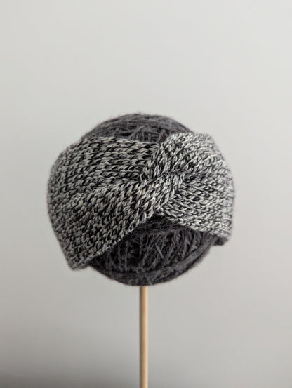 Knitted er warmer with a pattern on a gray background