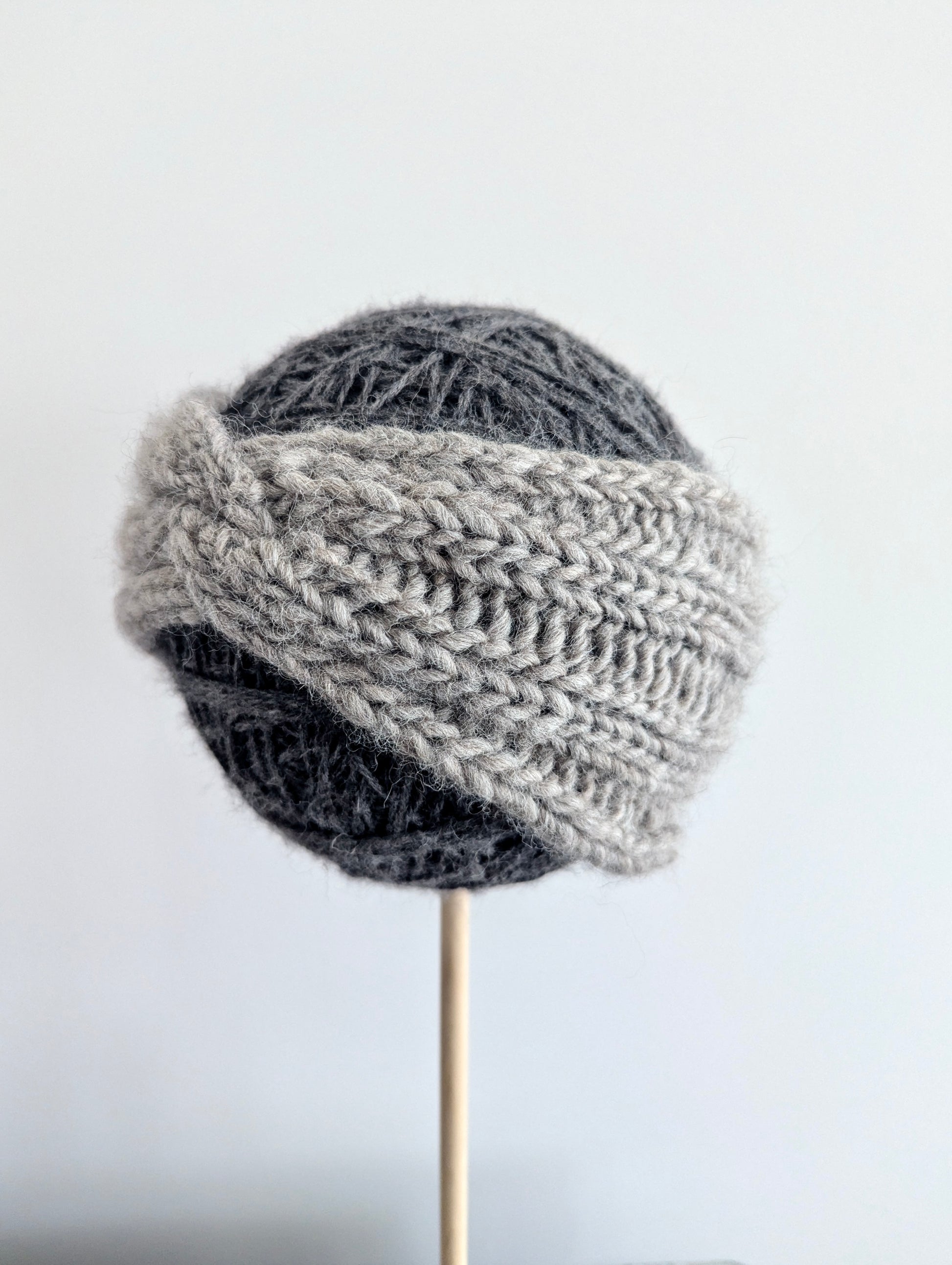 Knitted gray hat on a white background