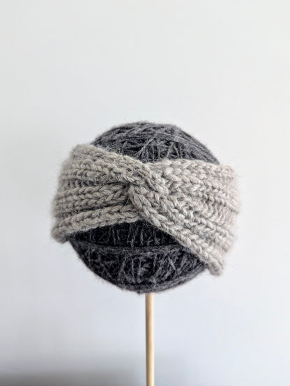 Knitted gray hat on a mannequin head against a white background