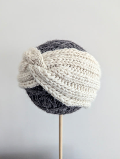 Knitted turban hat with two-tone design on a gray background
