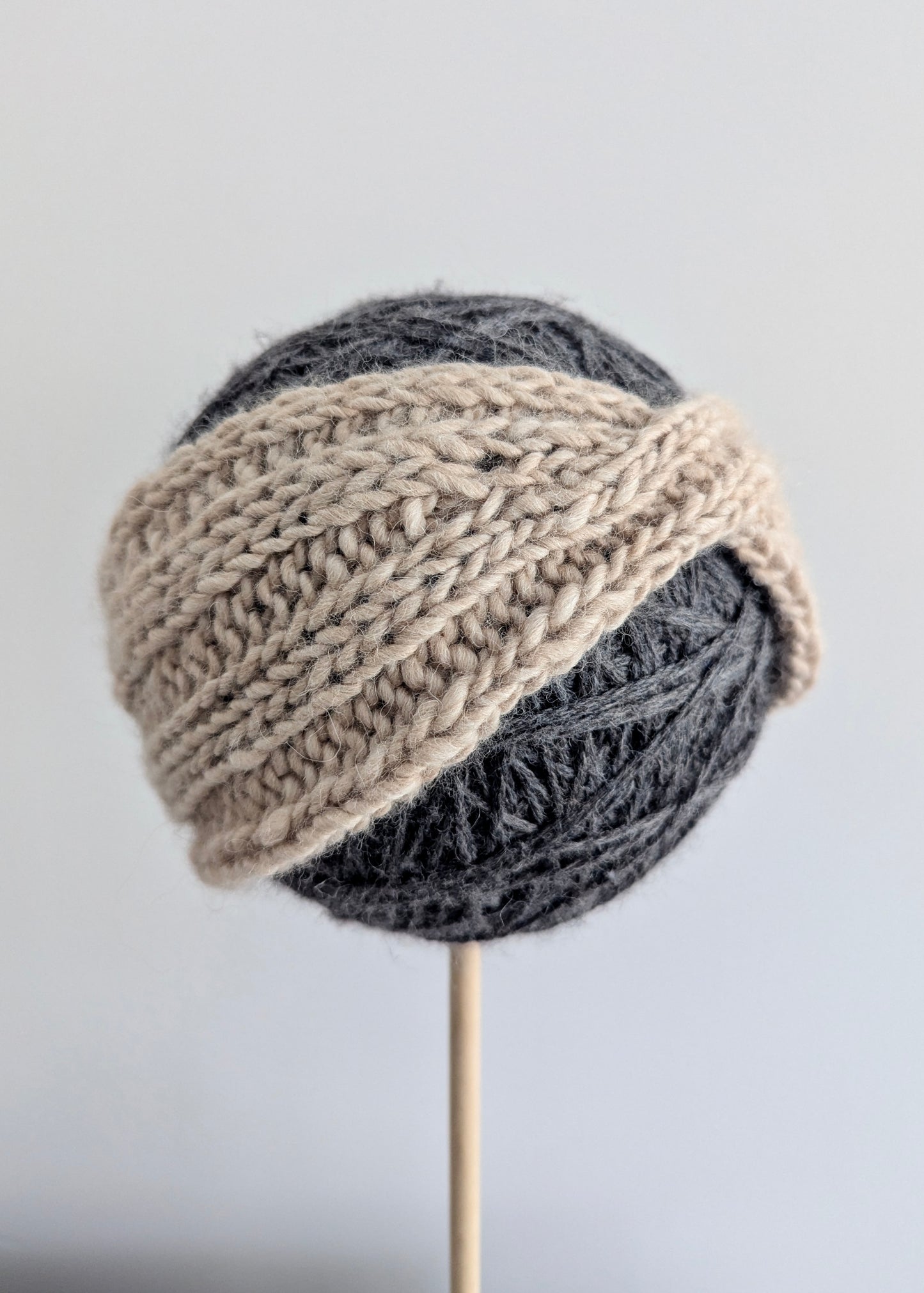 Knitted hat with two-tone design on a gray background