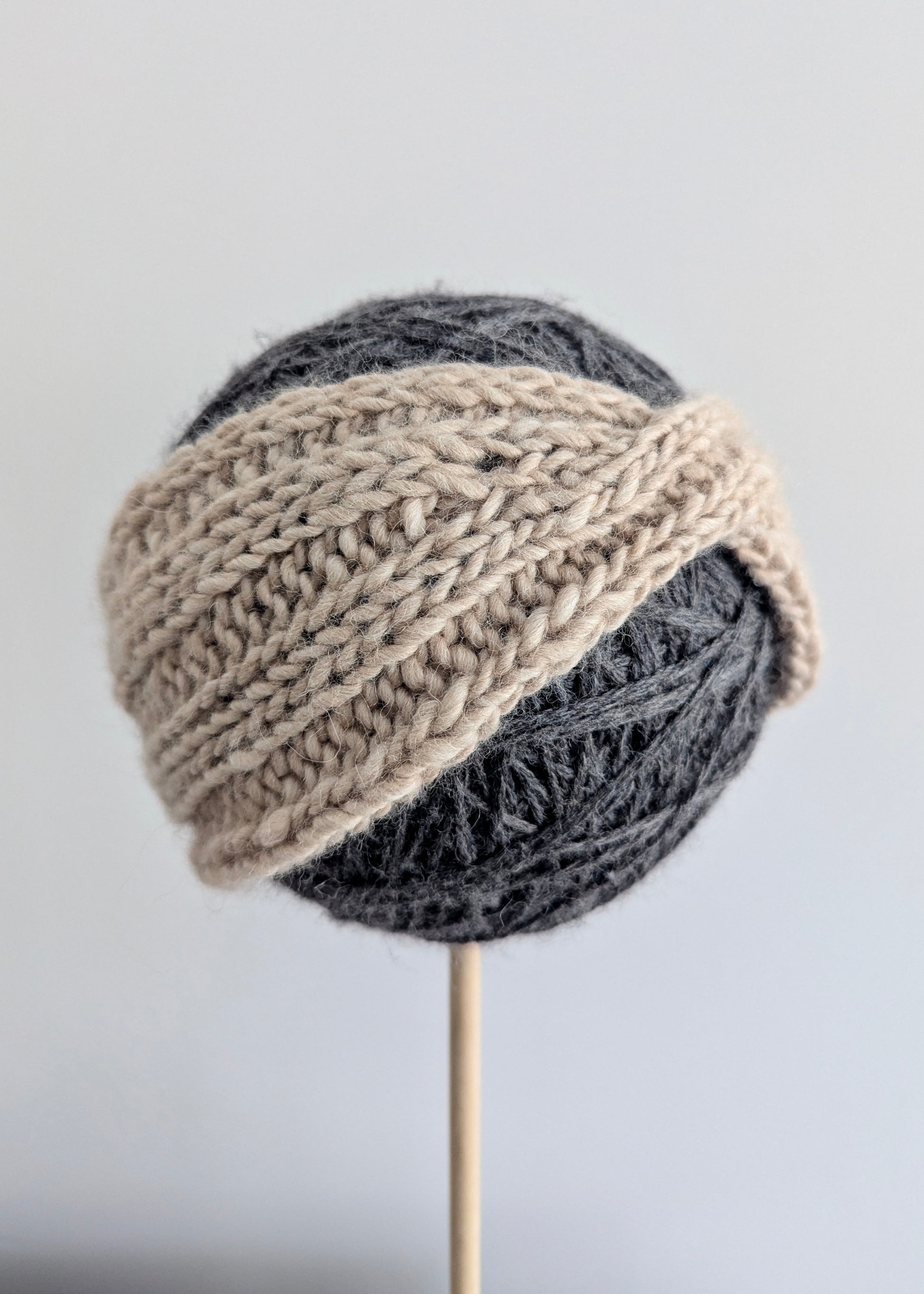 Knitted hat with two-tone design on a gray background
