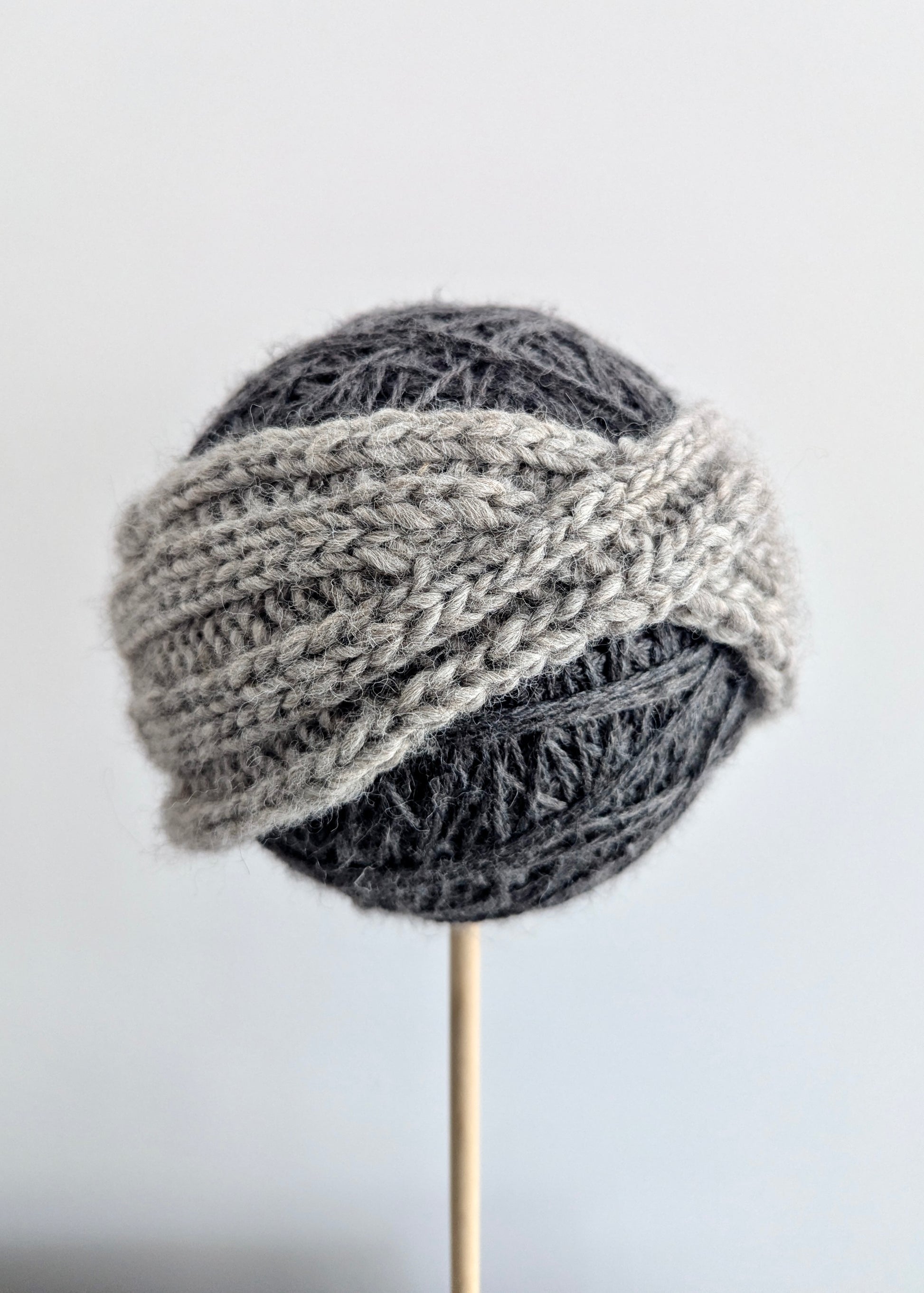 Knitted gray hat on a white background