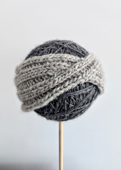 Knitted gray hat on a white background