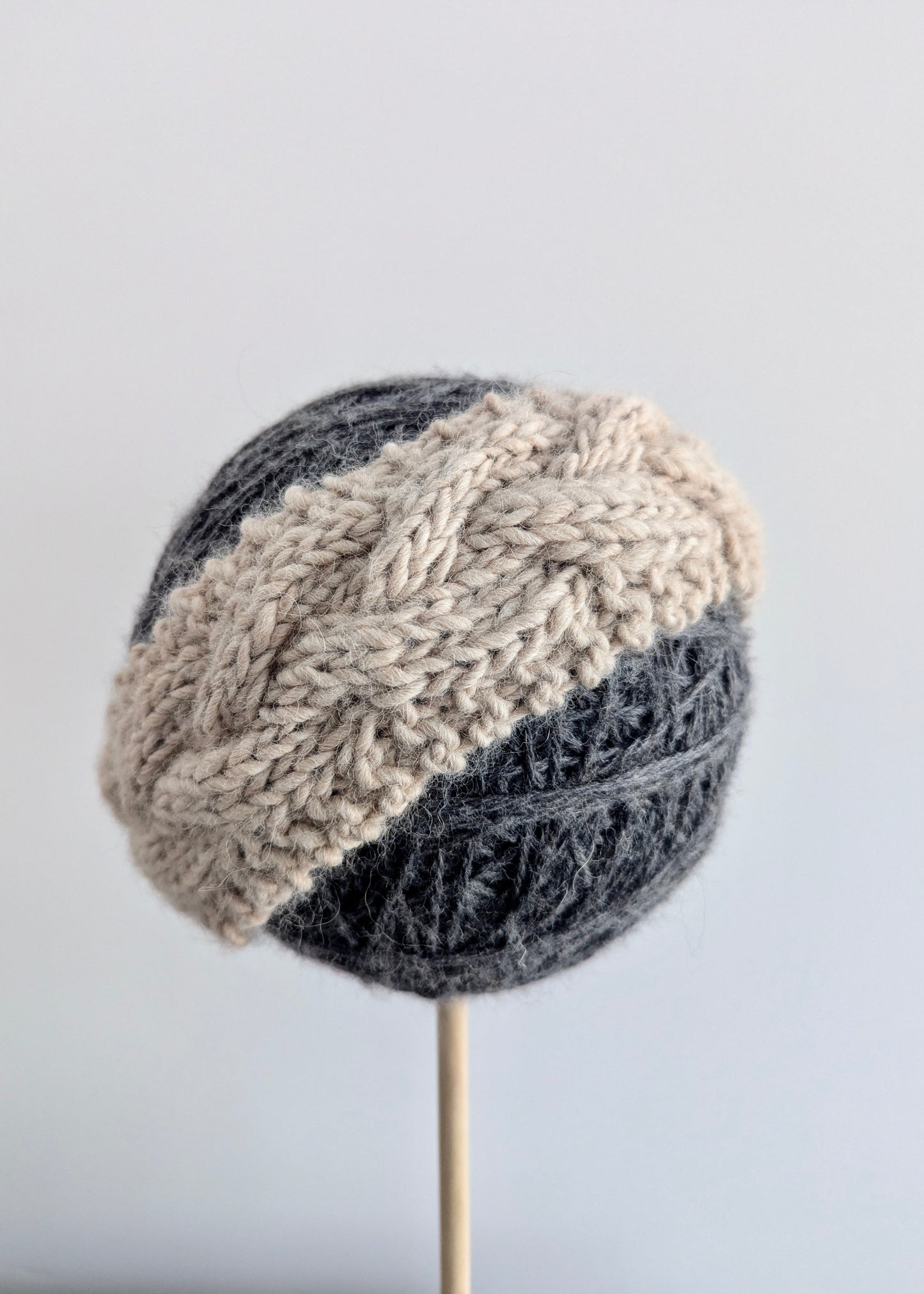 Knitted hat with two-tone pattern on a gray background