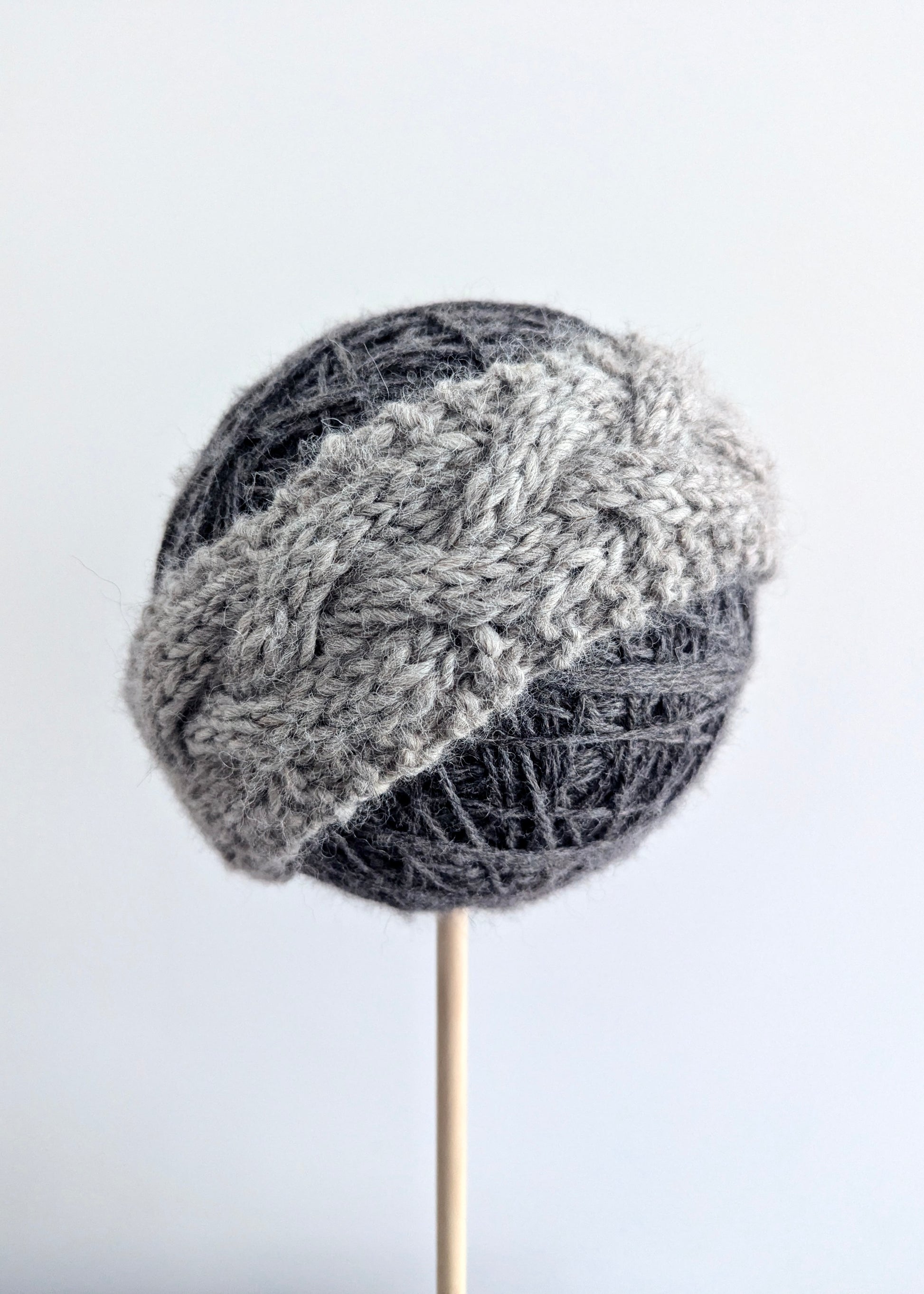 Knitted gray headband on a white background