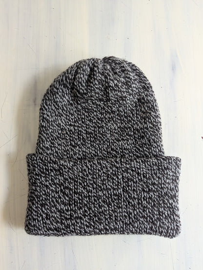 Knitted beanie hat on a white background