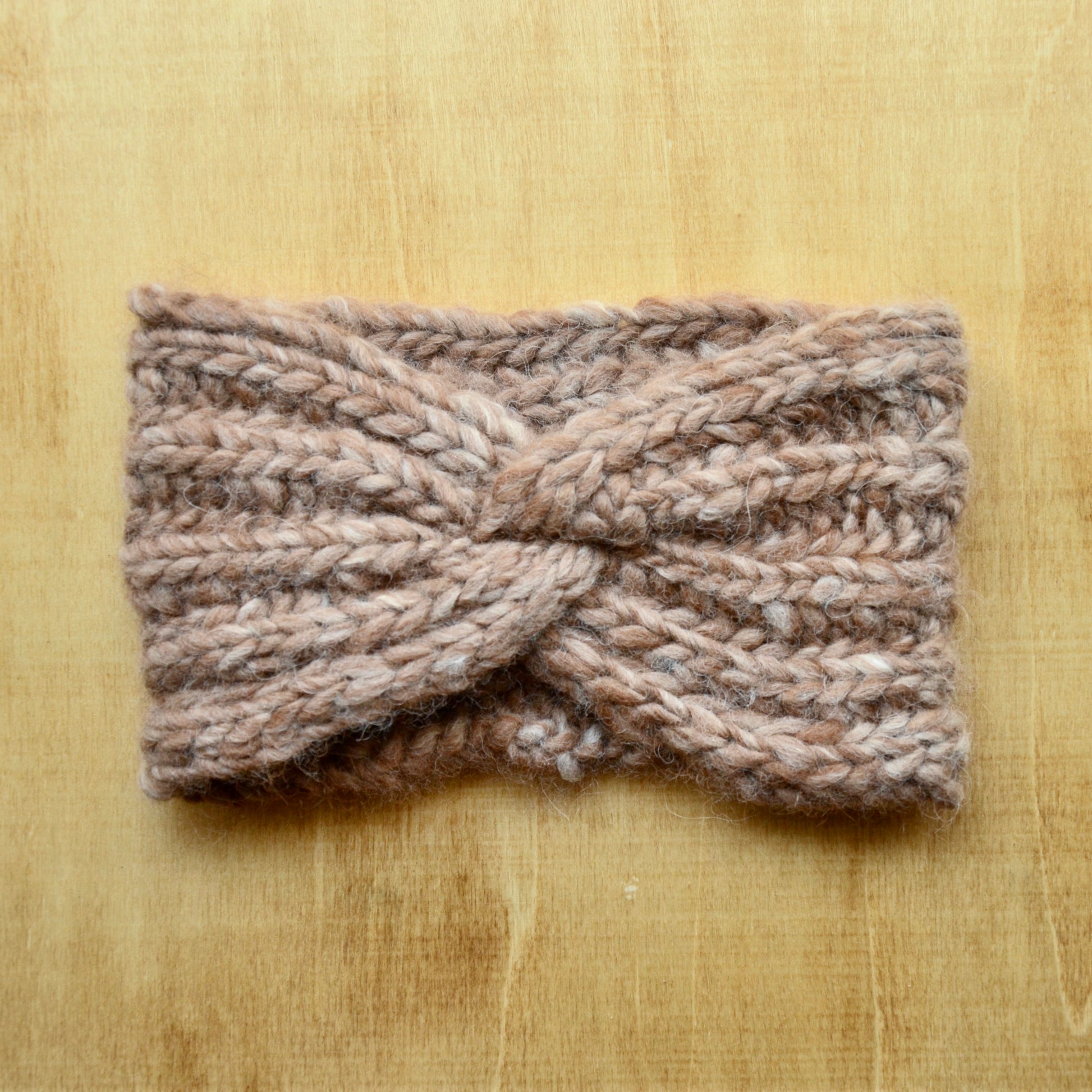 Fawn knit headband with brioche ribbing over a wood background