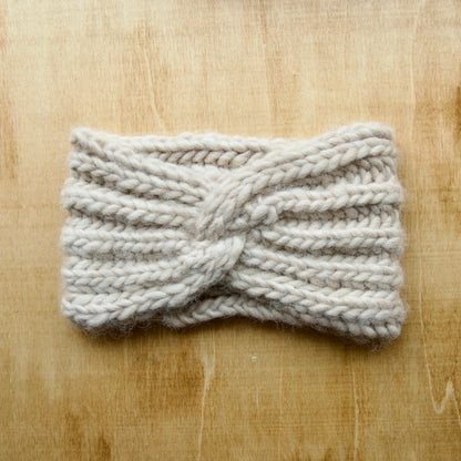 White knit headband with ribbing over a wood background