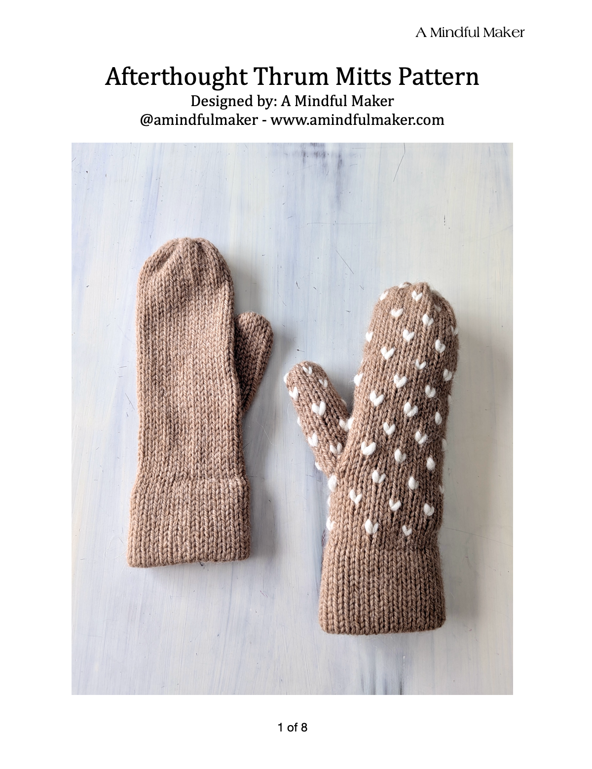 Knitted mittens with polka dot pattern on a light blue background, designed by A Mindful Maker.