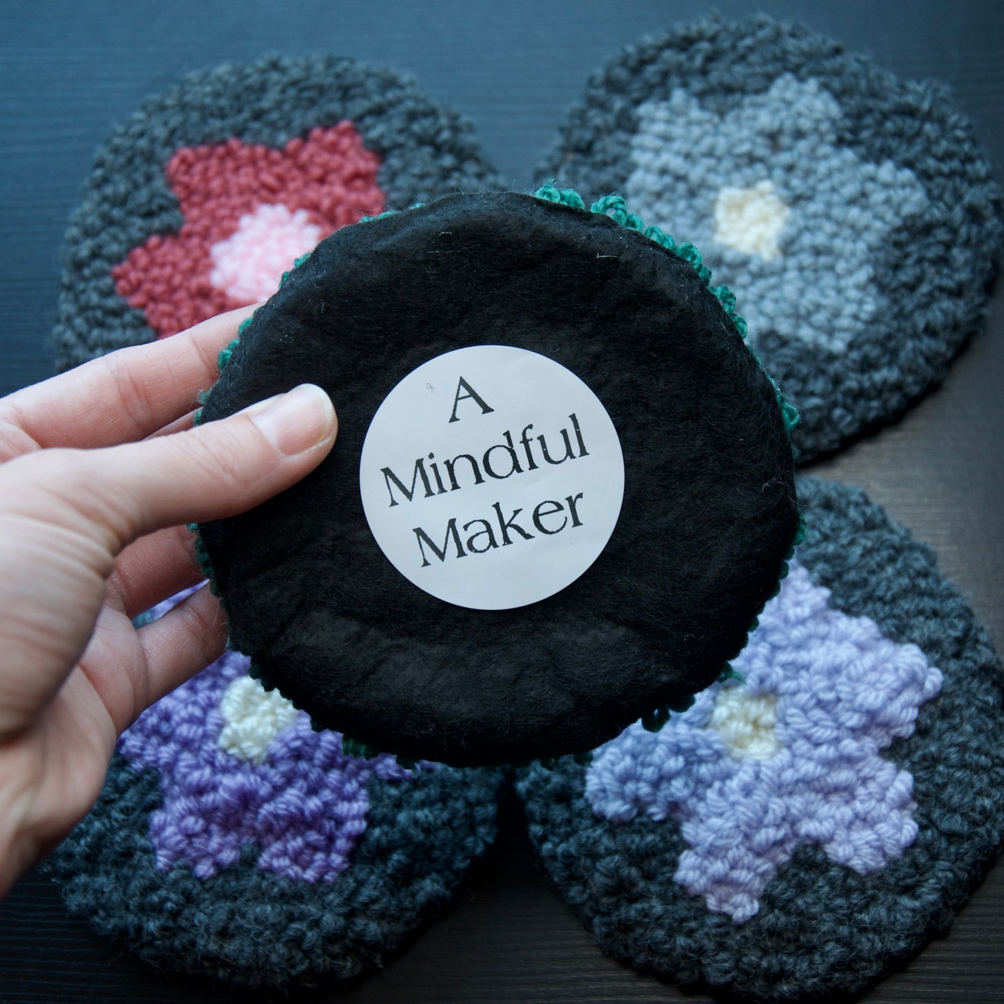 A set of round coasters with floral patterns in various colors.