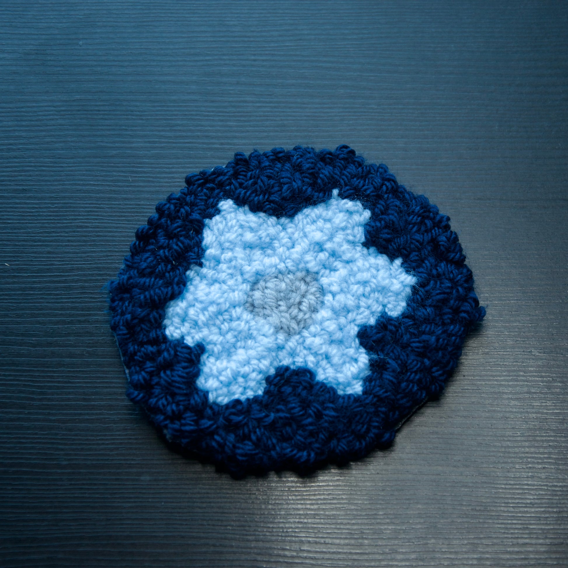 A set of round coasters with floral patterns in various colors.