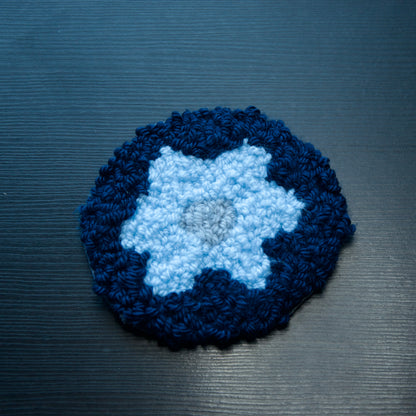 A set of round coasters with floral patterns in various colors.