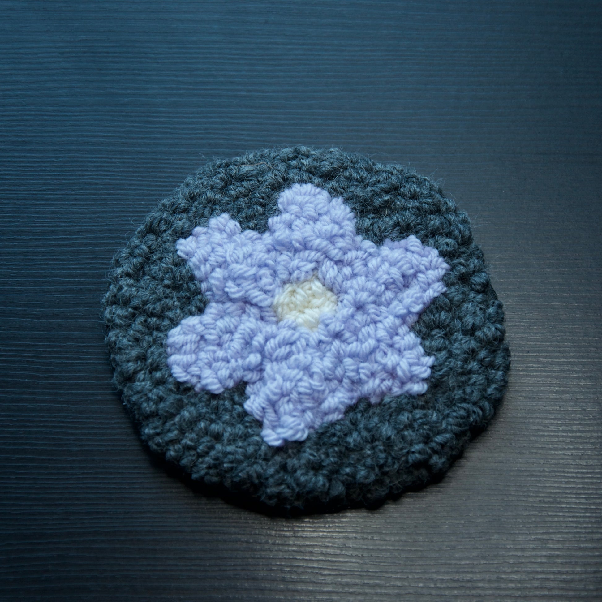 A set of round coasters with floral patterns in various colors.