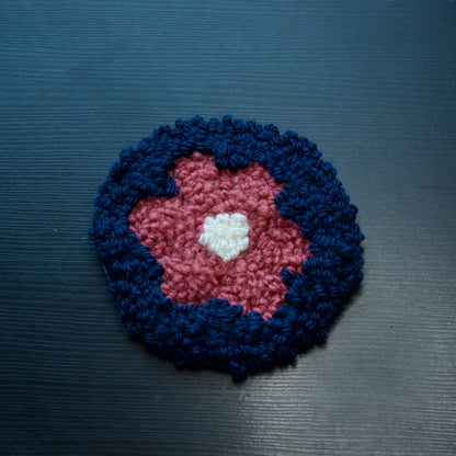 A set of round coasters with floral patterns in various colors.