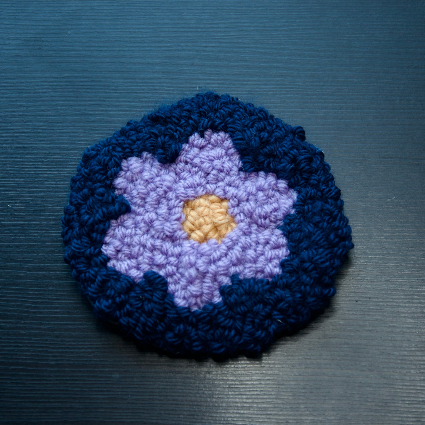 A set of round coasters with floral patterns in various colors.