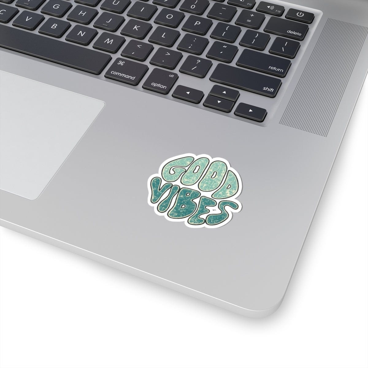 Laptop with a 'Good Vibes' sticker on the palm rest area